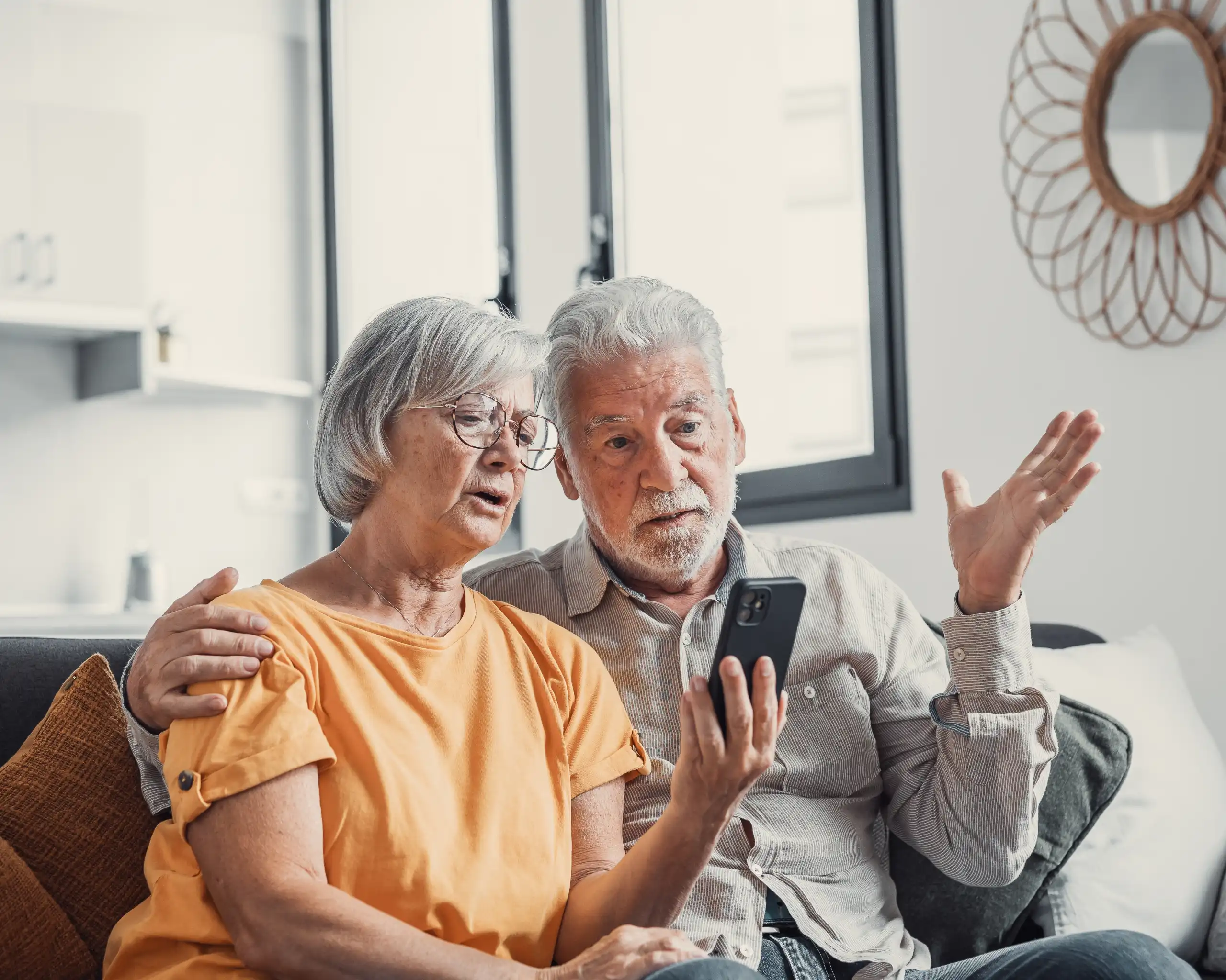 Frustrated couple looking at a cell phone